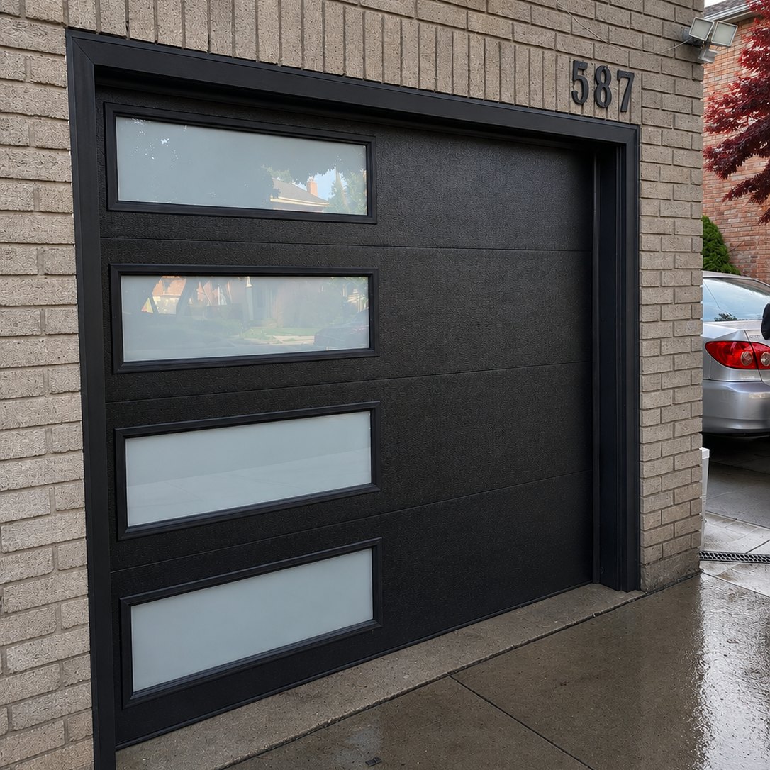 Black modern garage door with frosted glass panels on a GTA home