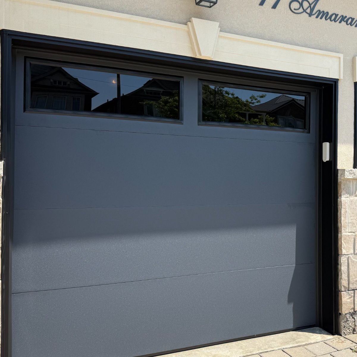 Grey flush-panel double garage door installed by Doorfect