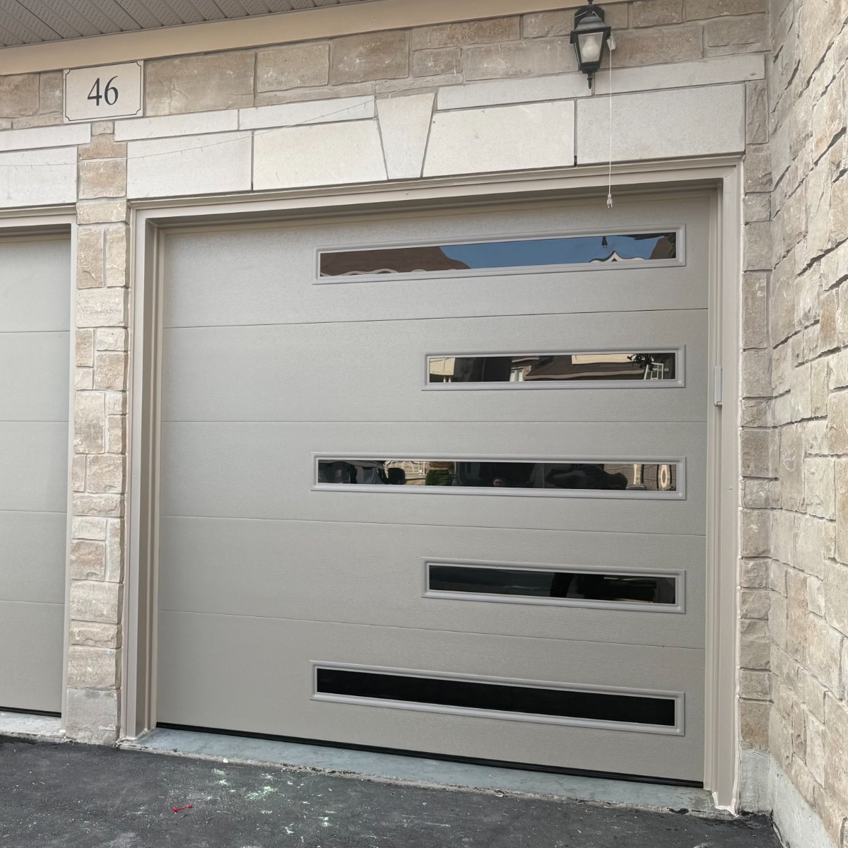 Sandstone garage door with window inserts installed by Doorfect