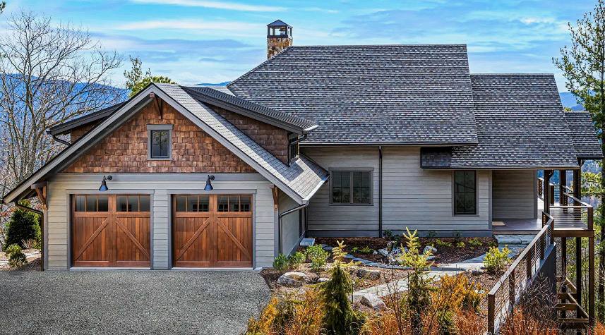 Custom wood carriage doors on a hillside GTA home