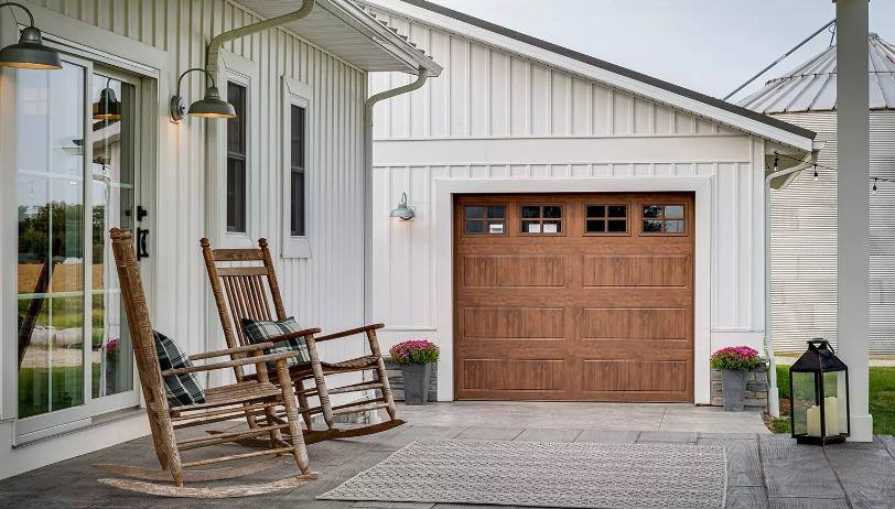 Wood-look single-bay garage door on a modern farmhouse
