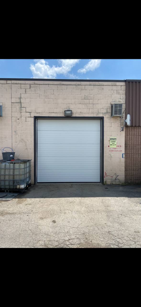 Newly installed commercial overhead garage door at a GTA business location